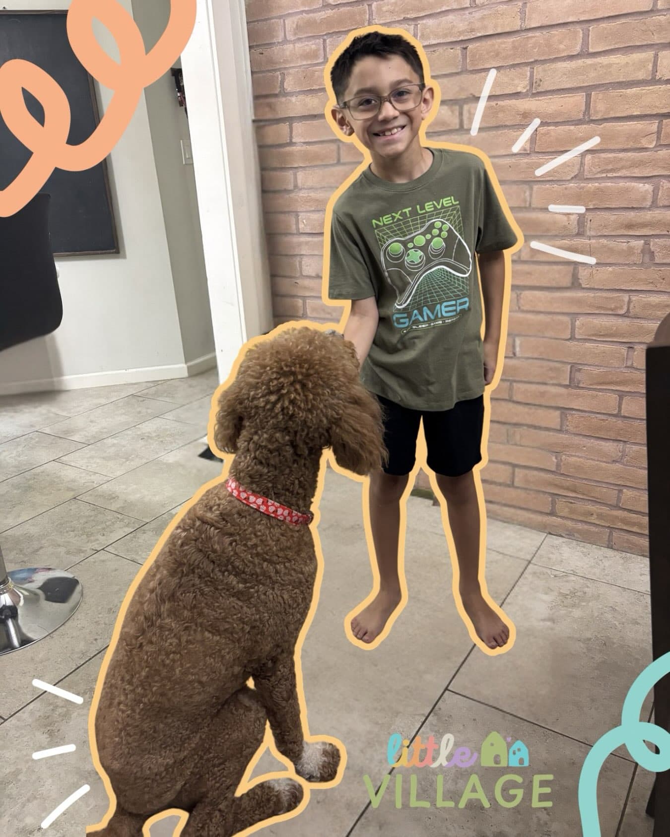 A little boy standing next to a brown dog.